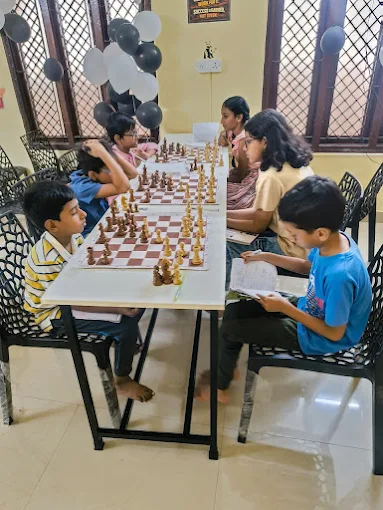 Children playing chess at tables during a class at a Chess Panda centre