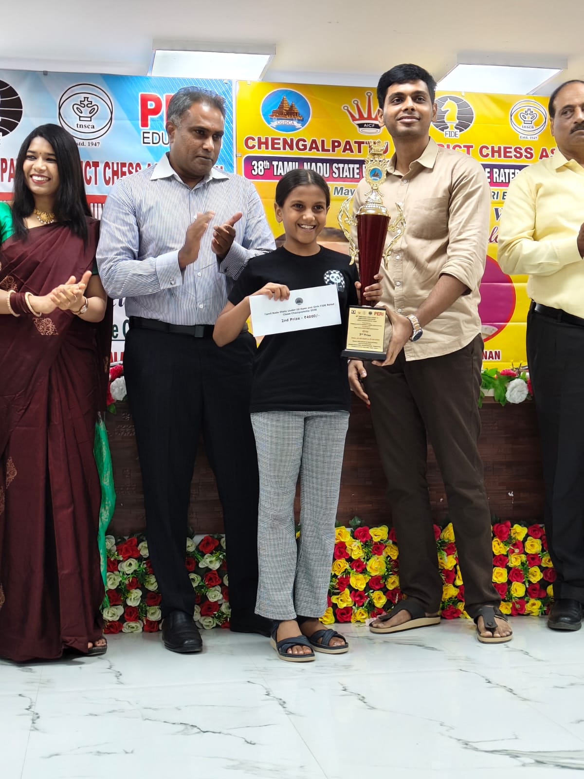 Presha, Chess Panda student, holding a tournament award