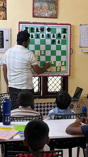 A Chess Panda coach showing a position on a wall demonstration board at a Chess Panda centre